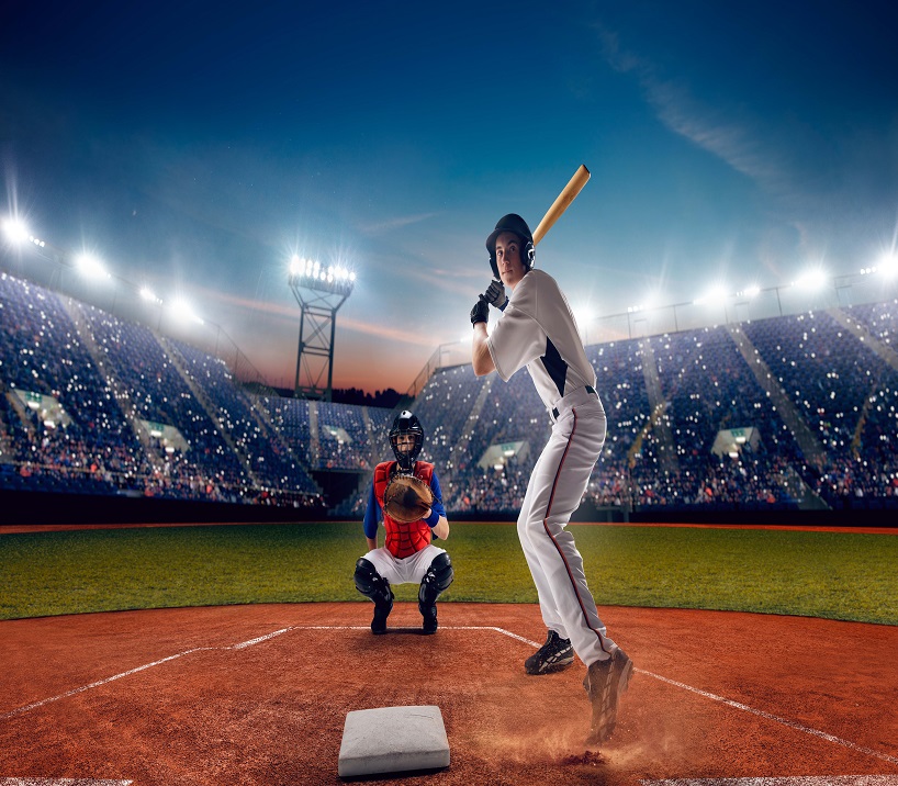 Youth baseball athletes competing in a professional stadium