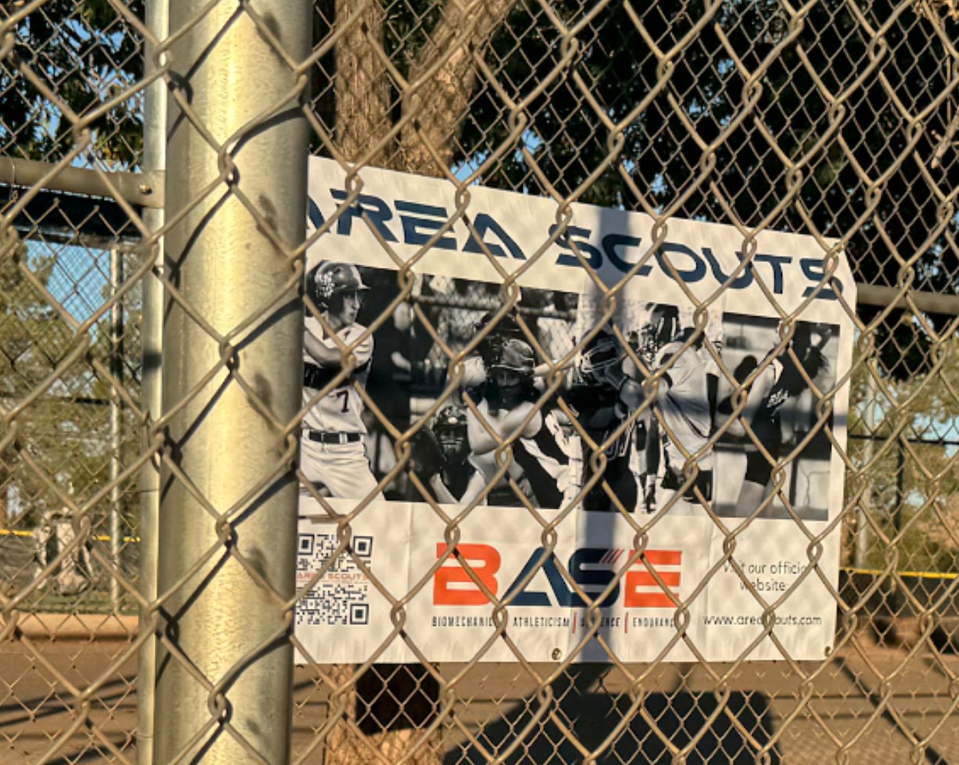Area Scouts B.A.S.E. banner on a youth baseball field fence